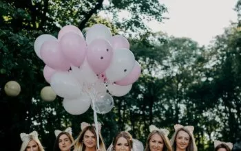 women standing side-by-side on street during daytime
